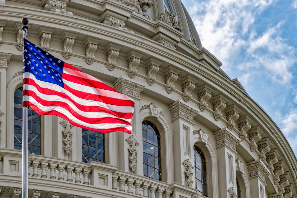 Washington DC Capitol dome detail with waving american flag